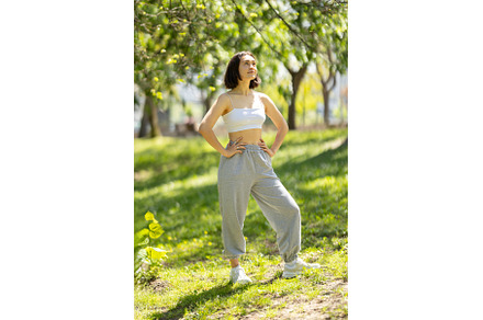 A woman is standing in a park