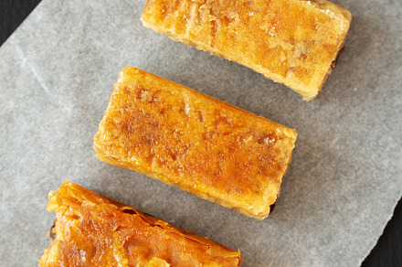 Homemade Baklavas with Honey, Chocolate and Almond on a black ba, a Food & Drink Photo by LiudmylaChuhunova