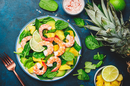 Fresh pineapple salad with shrimps, spinach, avocado and lime on, a Food & Drink Photo by 5PH