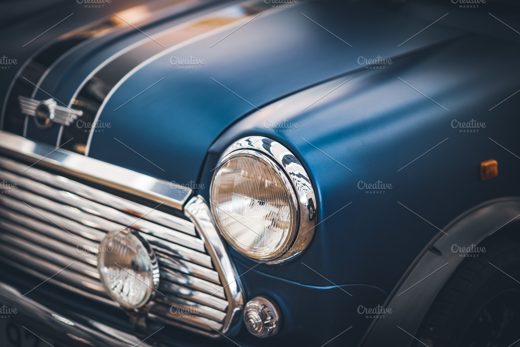 Headlamps and grille of a blue car, a Transportation Photo by Visual Motiv