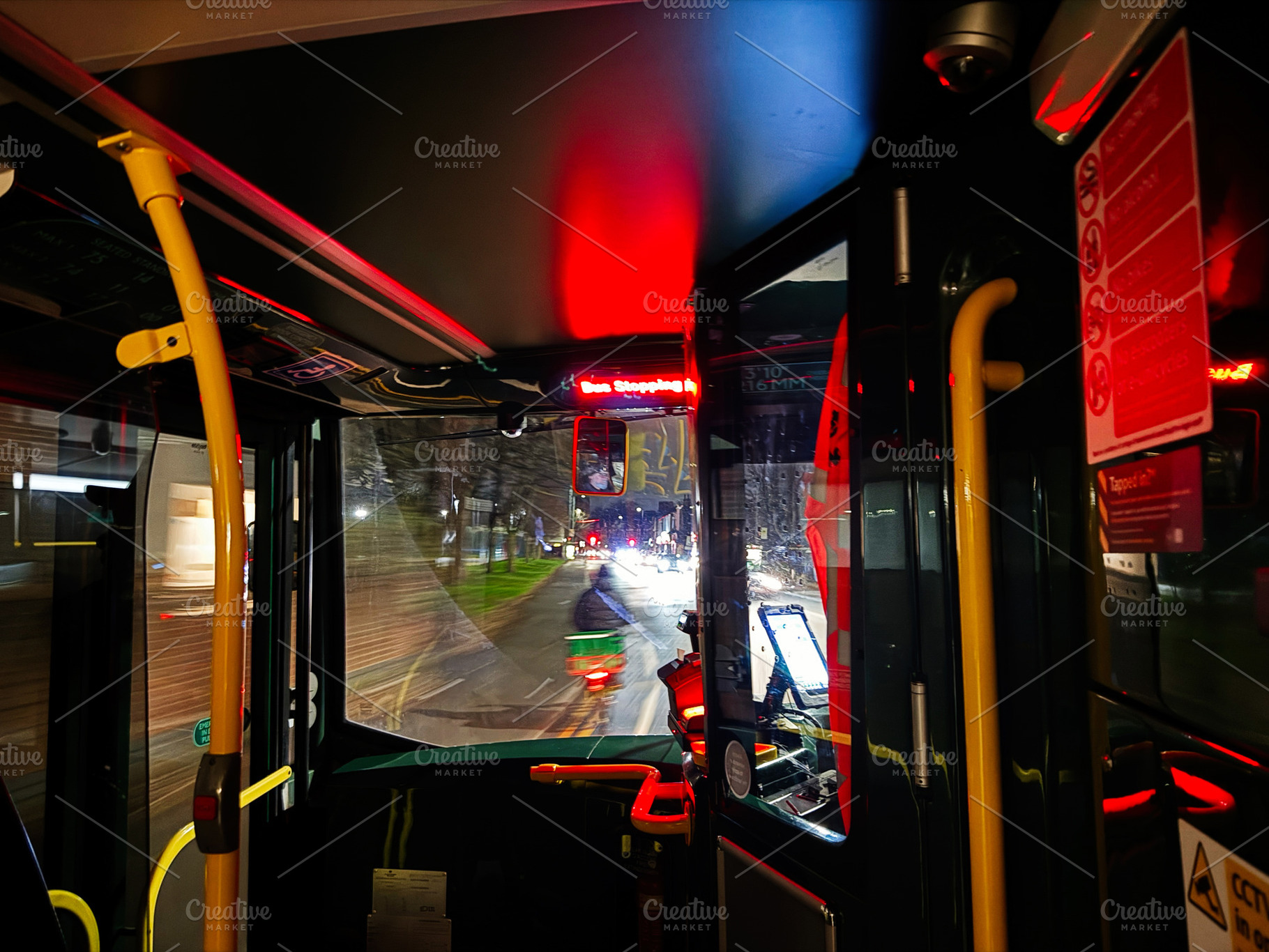 Night bus ride inside a Manchester bus with red interior lights and city street, a Photo by AS photostudio