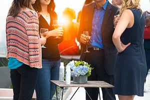 Businesspeople enjoy drinks on event