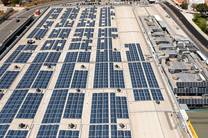 Aerial view of extensive solar panel installation on commercial rooftop, a Photo by andreonegin market
