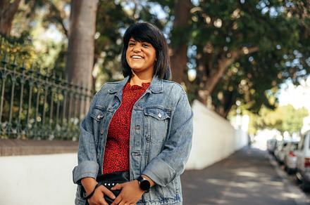 Happy mid-adult woman smiling at the camera outdoors, a Person Photo by Jacob Lund