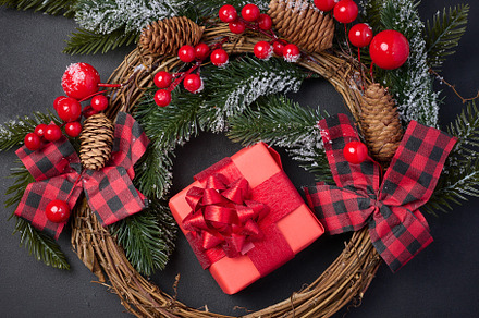 Christmas wreaths, fir branches and gifts on a black background., a Holiday Photo by ndanko