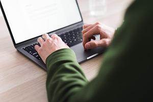 Young millennial man working on his featuring agency, blog, and business