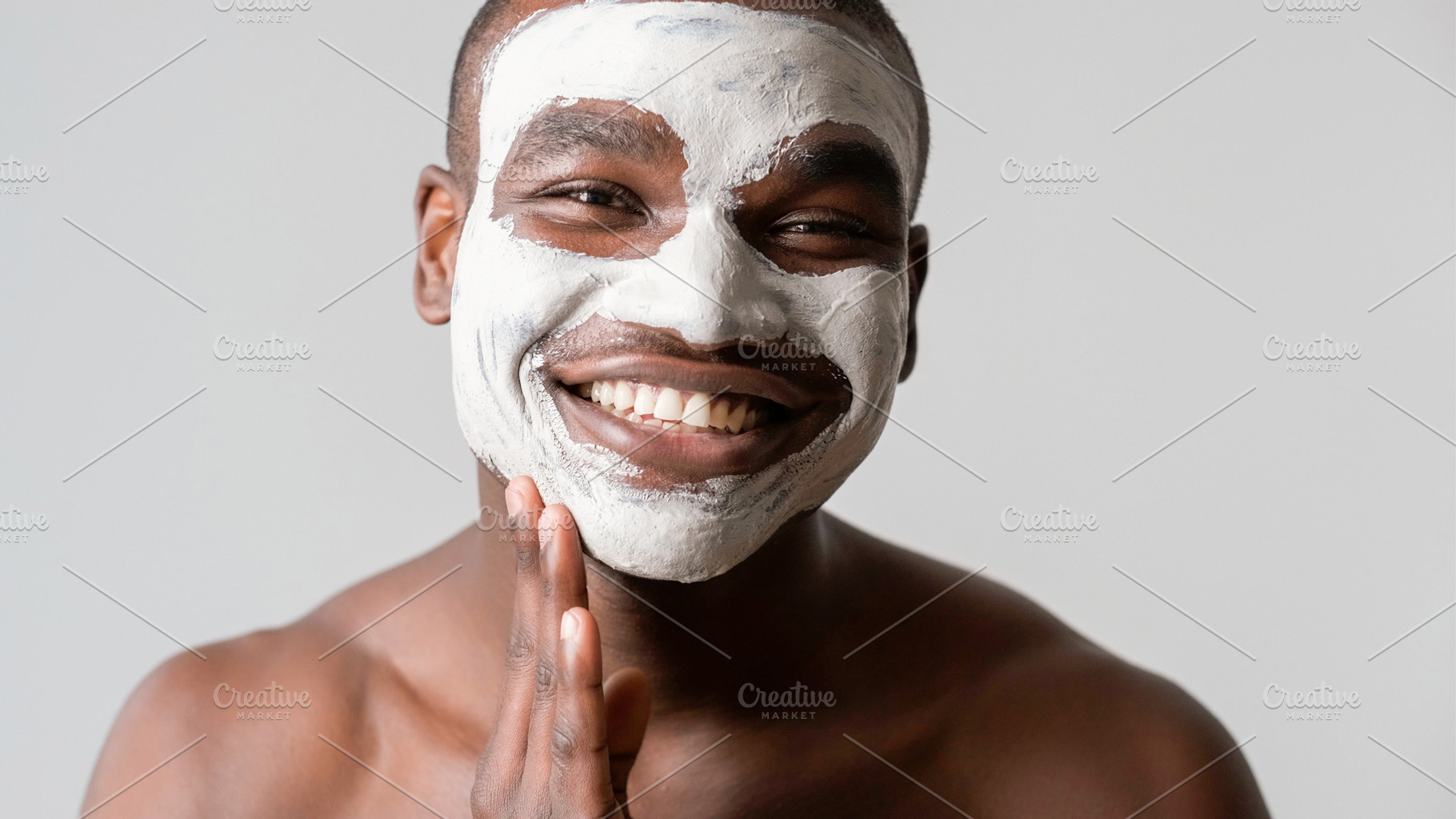 Man cosmetic facial mask applying cleaning clay, a Photo by Photo Drive Studio