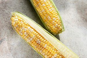 Fresh corn cobs on concrete background, a Food & Drink Photo by Olena Rudo