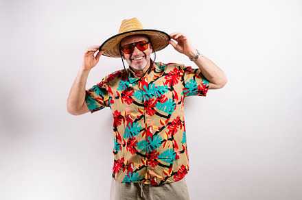 Smiling tourist in tropical shirt and straw hat