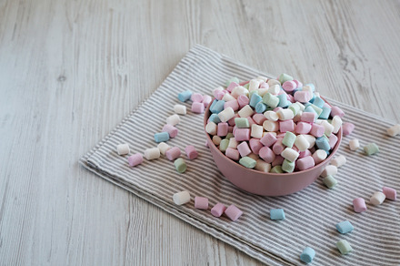 Rainbow Fruity Mini Marshmallows in a Pink Bowl, side view. Copy, a Food & Drink Photo by LiudmylaChuhunova