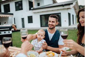 Family toasting with wine during, a Person Photo by HalfPoint
