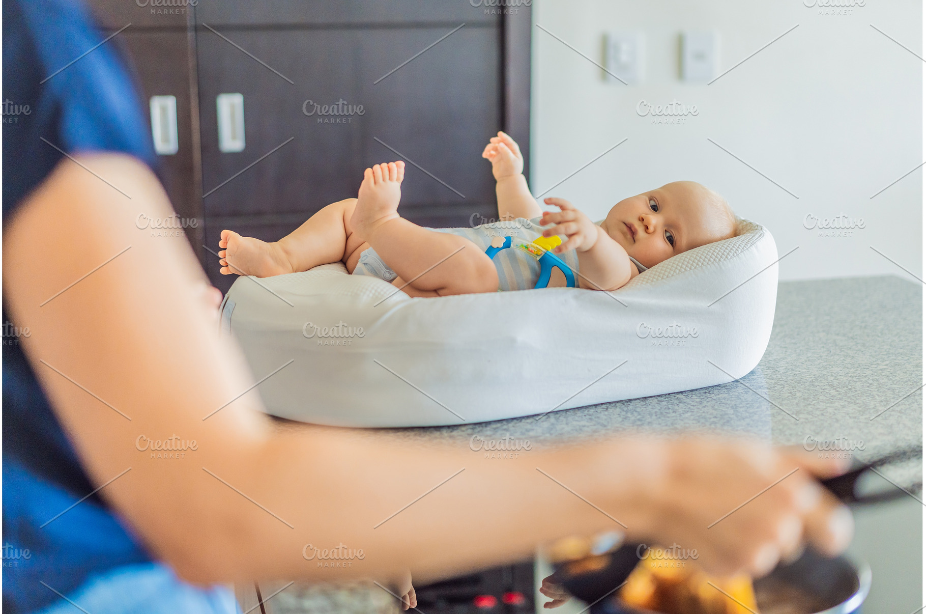 Mother talking to baby lying in cozy, a Person Photo by Elizaveta Galitskaya