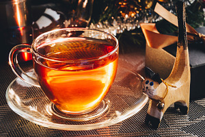 Christmas presents containing tea, cup, and background
