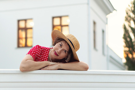 Woman in red polka-dot dress rests
