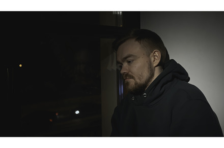 Sad man at night window of house, a Person Photo by Media Whale Stock
