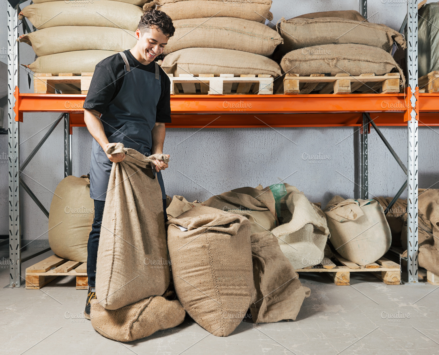 Warehouse worker folding a bag with, a Person Photo by Artem Varnitsin