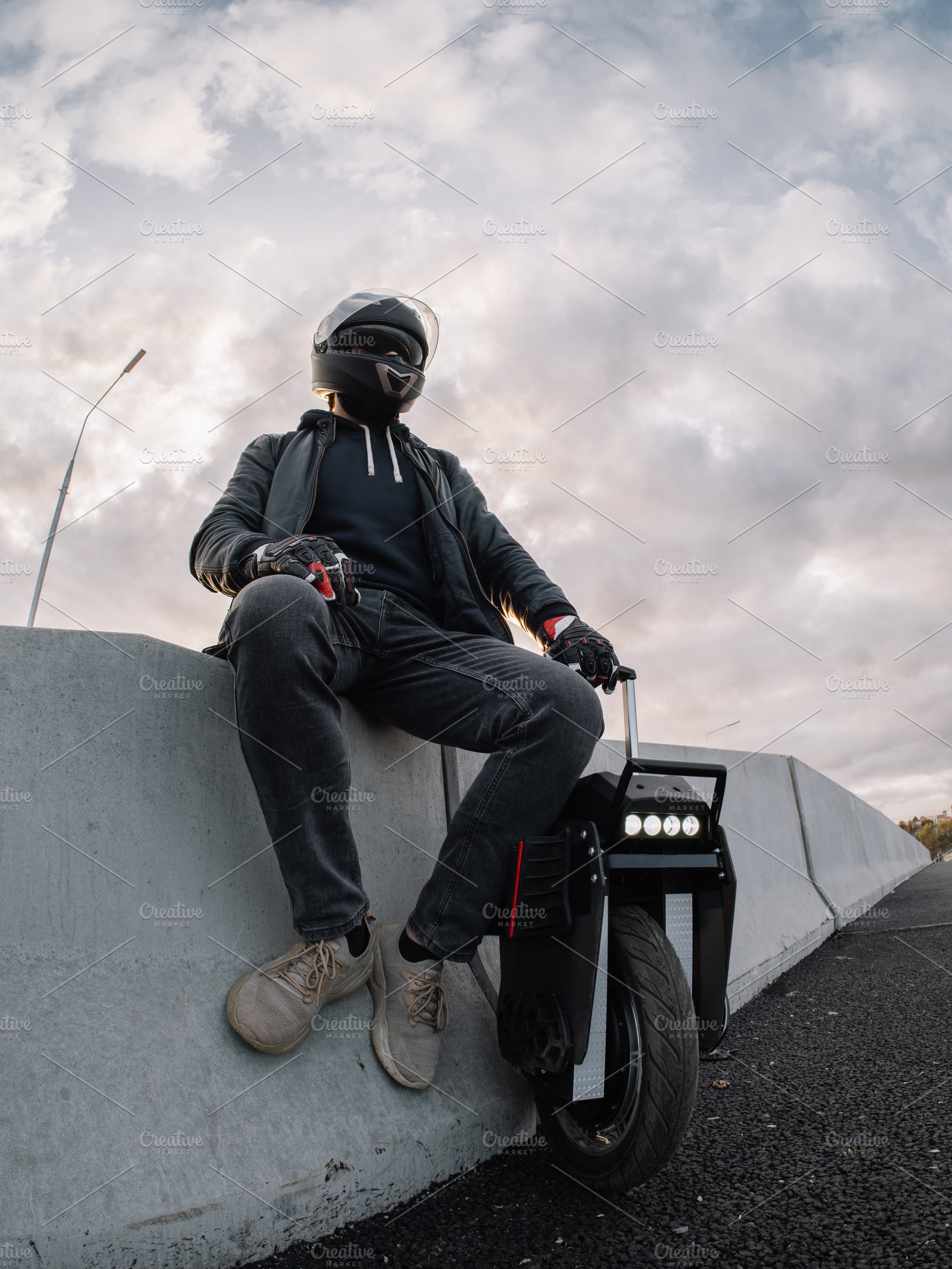 A male rider in protective gear riding an electric wheel. Urban, a Person Photo by PavelKant