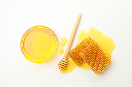Dipper, bowl with honey and honeycombs on white background, a Food & Drink Photo by AtlasStudio