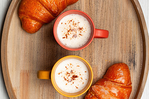 Waiters carrying breakfast tray with cappuccino and croissants, a Food & Drink Photo by Antonio Gravante Market