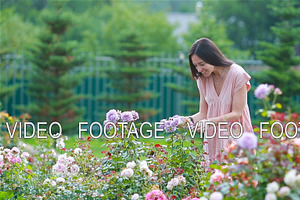 Young Girl In A Flower Garden Among