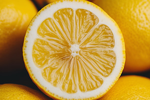 Close up of a juicy lemon half place, a Food & Drink Photo by MistyDay