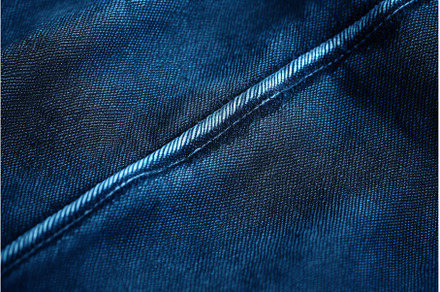 Close up of blue denim fabric, a Background Photo by Ylivdesign