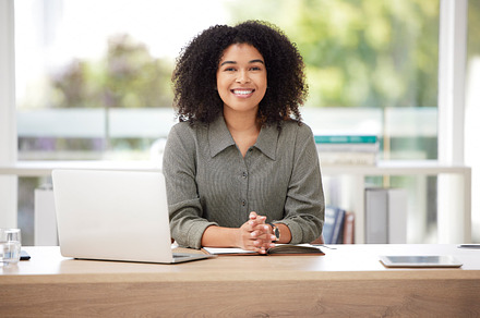 Happy, smile and laptop with portrait of black woman in office for proposal, executive and corporate project. Technology, internet and professional with employee for email, report and research, a Photo by Peopleimages.com