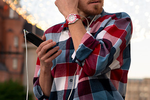 Man adjusting earphones while listen, a Person Photo by Elena Vagengeim