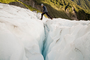 Ice Climber Crossing Crevasse, a Person Photo by THP Creative