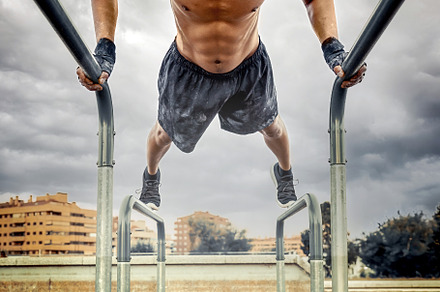 Man exercising on parallel bars outd, a Sports & Recreation Photo by Perpis