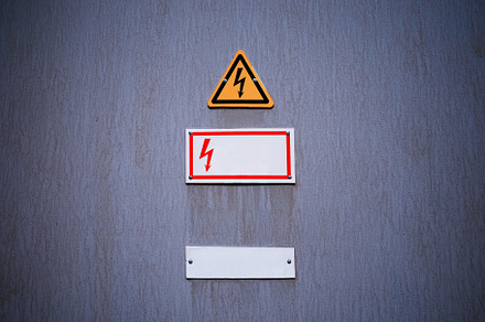 Electricity danger sign on vintage wall background, an Industrial Photo by RETROWAVE '88