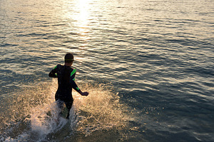 Athlete triathlon in front of a sunr stock photo containing triathlon and