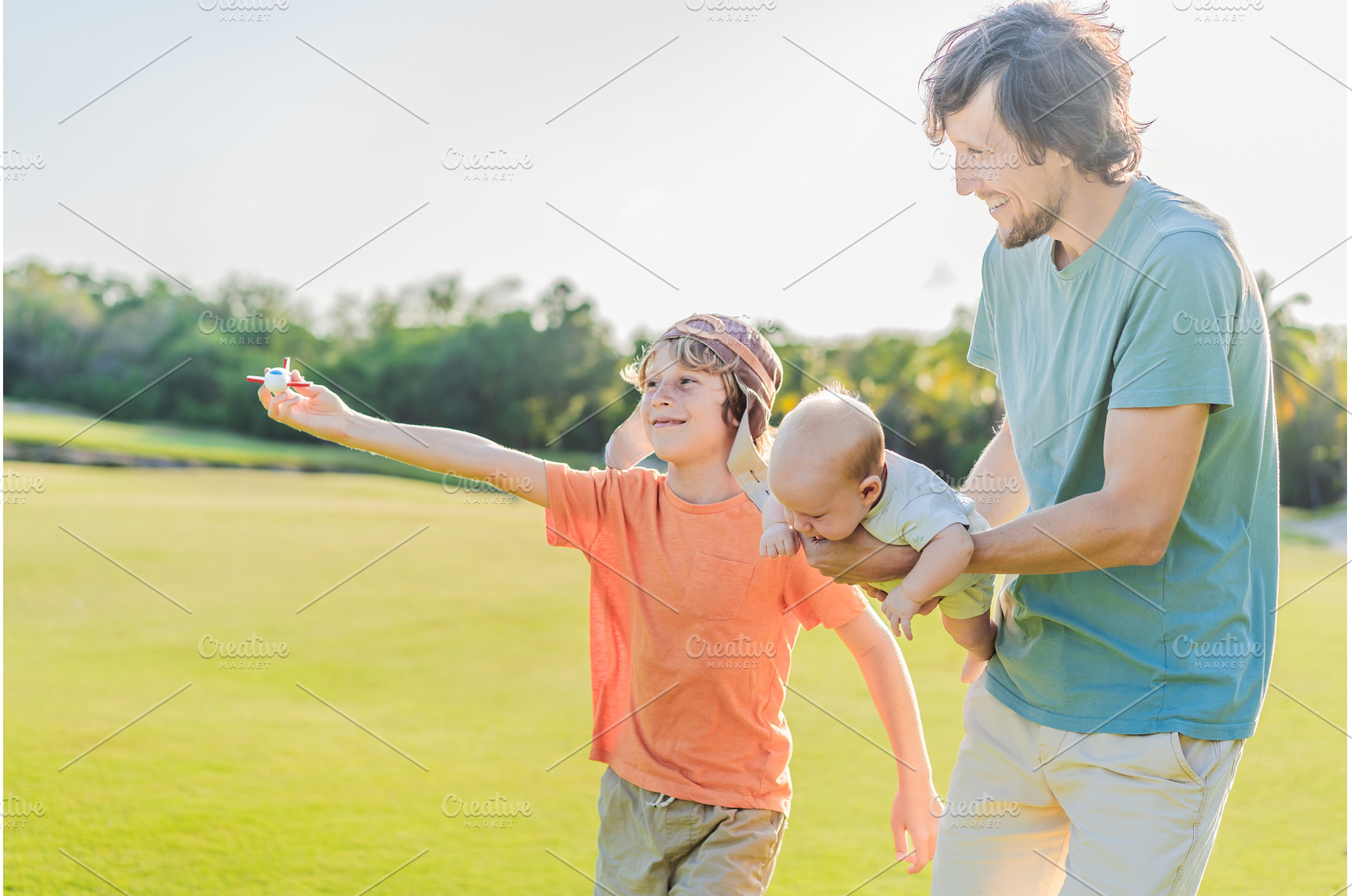 Father with his two sons in the park, a Person Photo by Elizaveta Galitskaya