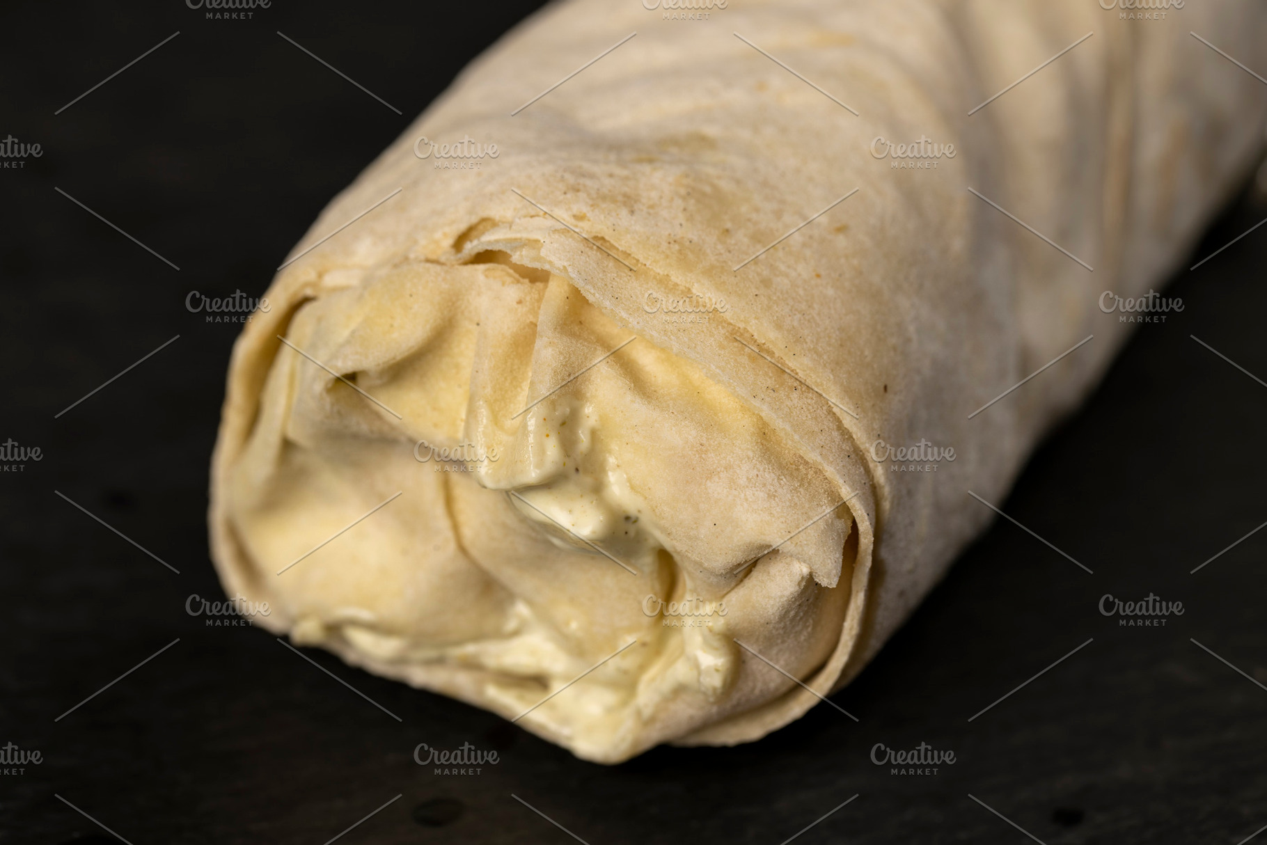 shawarma from thin tortilla with meat with tomatoes and sauce, fast food made f, a Photo by rsoollAI