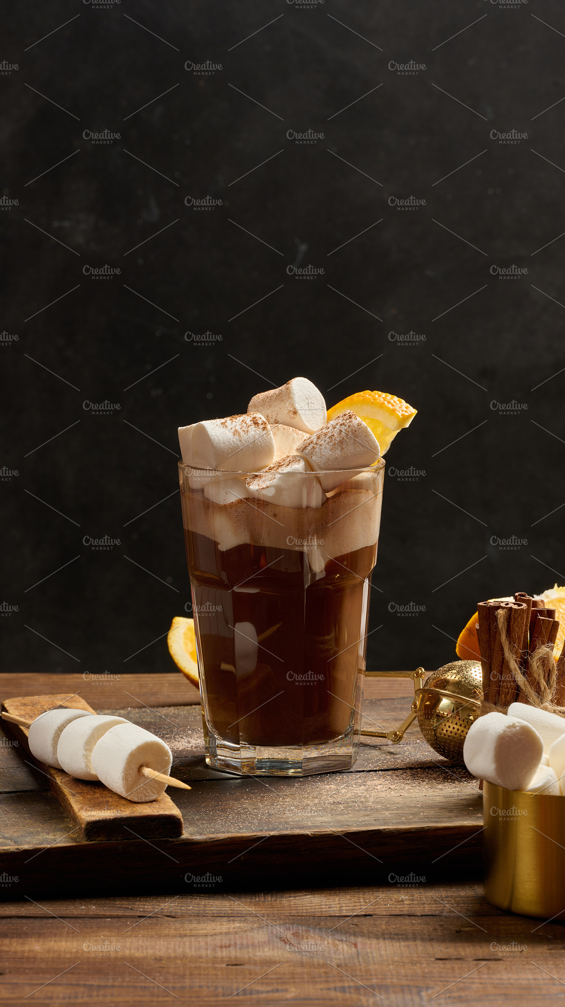A glass of hot chocolate with white marshmallow pieces on a wood, a Food & Drink Photo by ndanko
