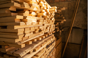 Dry wooden planks stacked inside, an Industrial Photo by volodymyrshtun13795