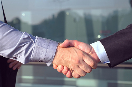 Close up of successful businessmen containing agreement, arm, and building