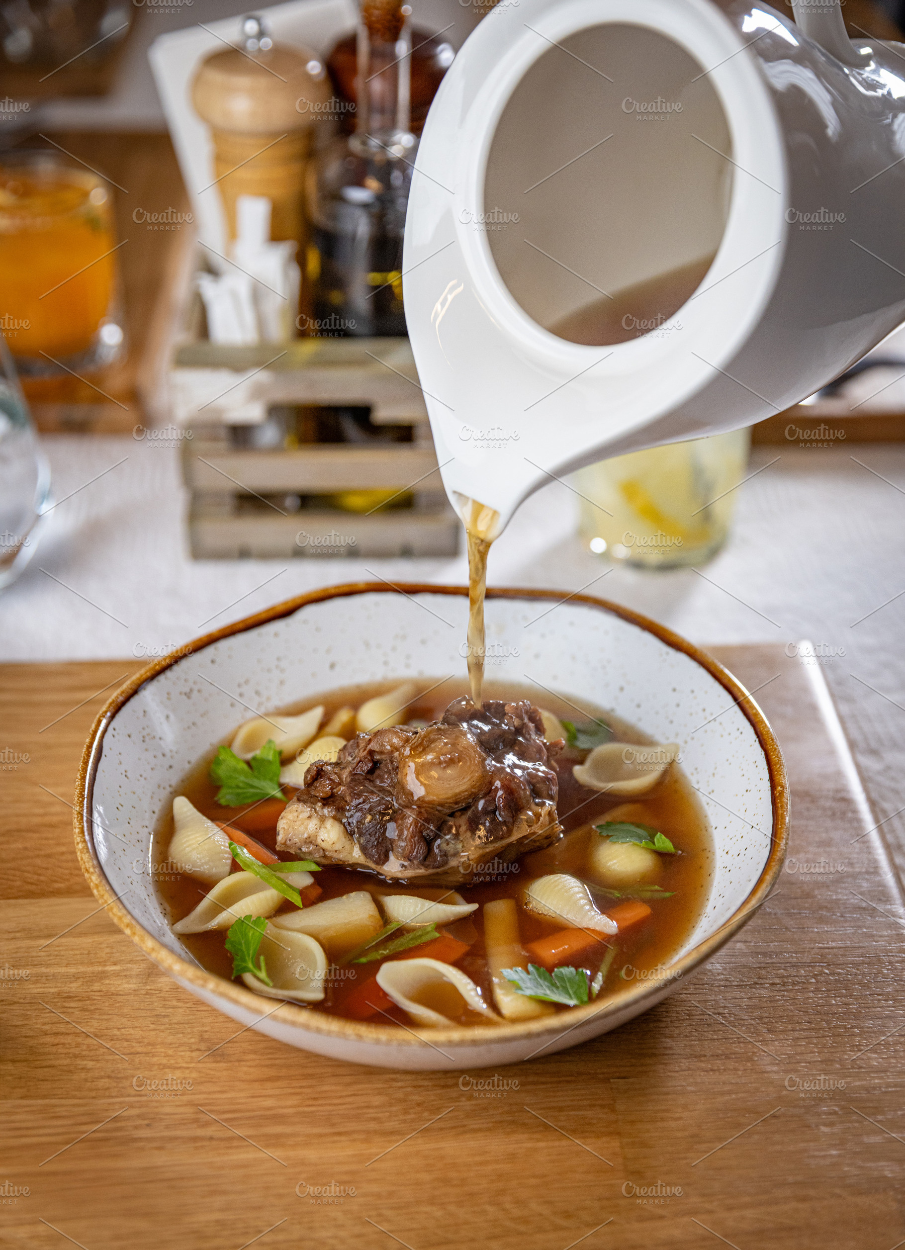 Oxtail soup being served in a restaurant, a Photo by Grafvision photography