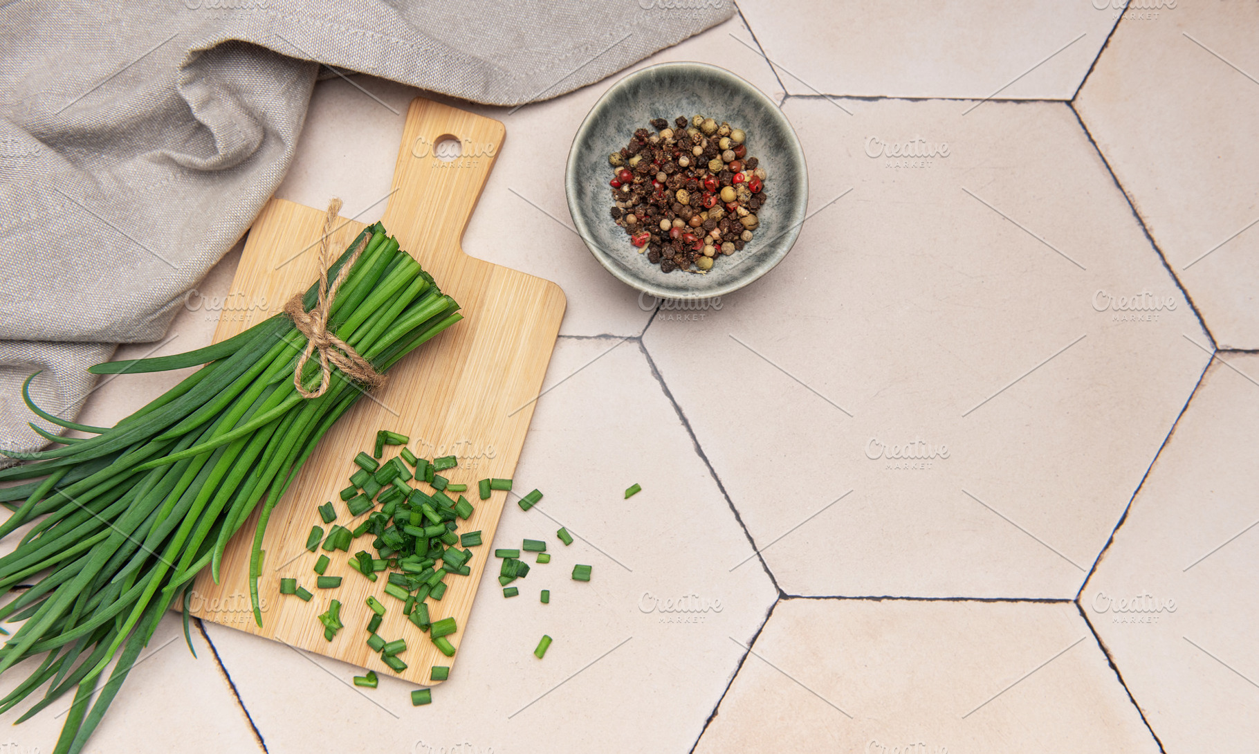 Fresh chives and peppercorns on rustic tile background, a Food & Drink Photo by Olena Rudo
