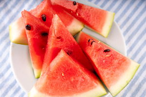 Raw ripe organic watermelon slices on kitchen table, a Food & Drink Photo by Rimma