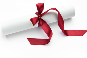 Diploma scroll with red ribbon symbolizing achievement and succe, a Holiday Photo by Olena Rudo