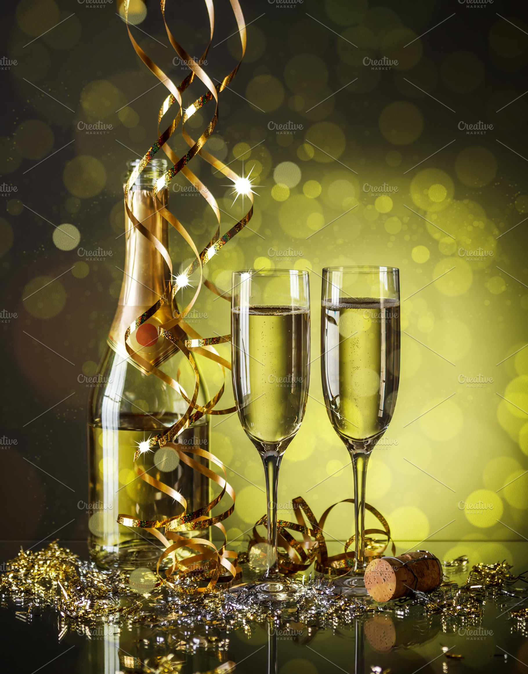Two champagne glasses containing new, year, and eve