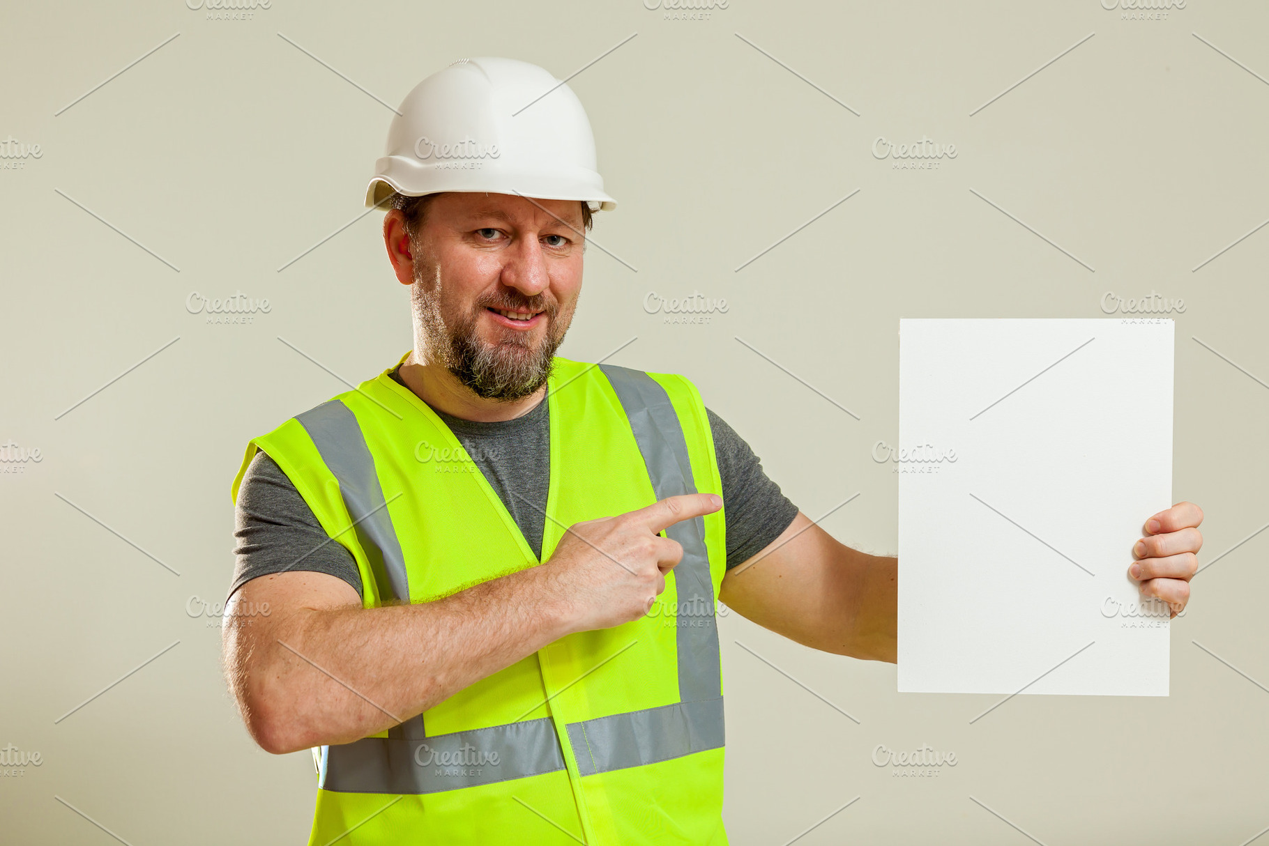 worker in a vest and white helmet, a Person Photo by Photostock