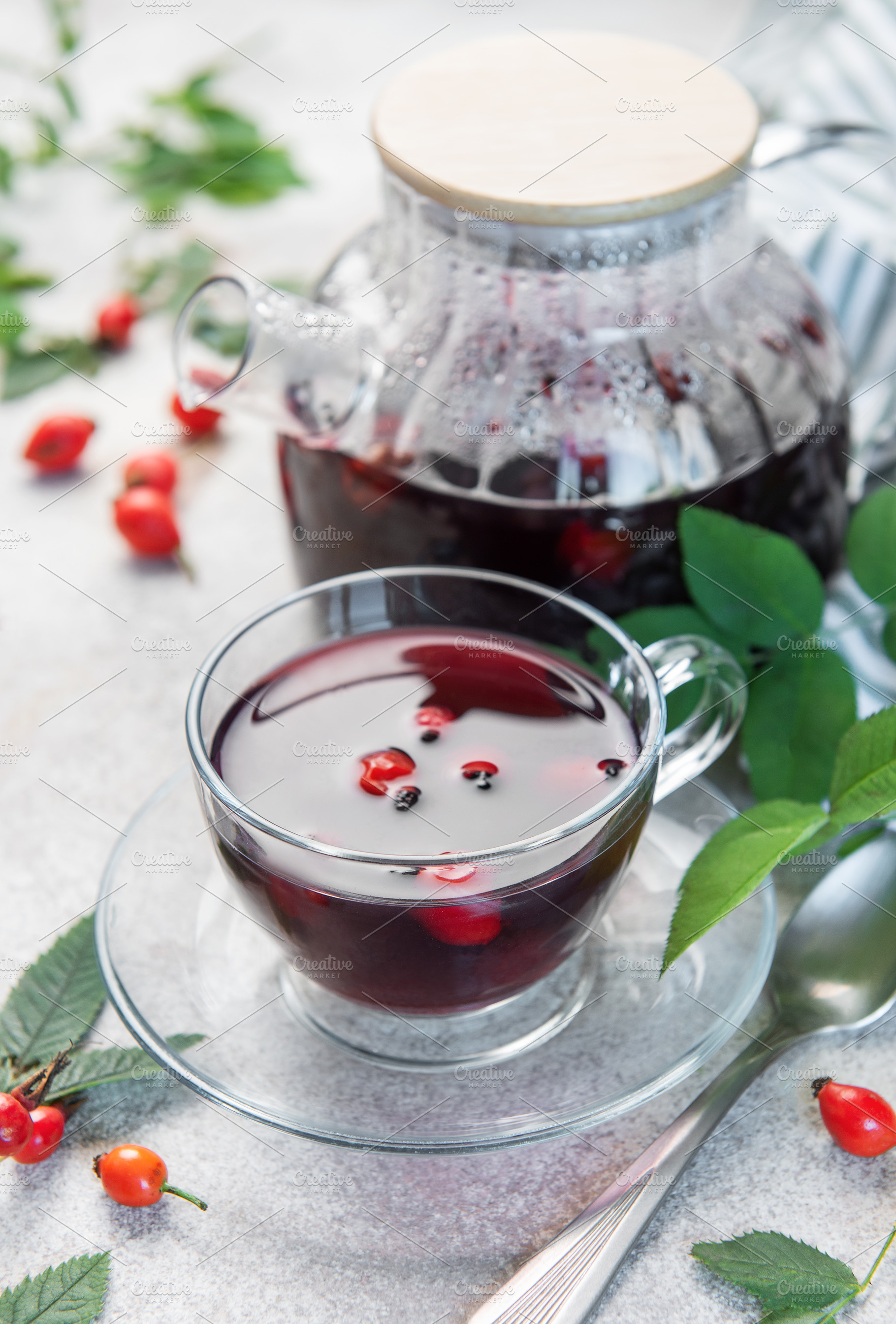 Rosehip tea brewing in glass teapot and cup with fresh rose hips, a Food & Drink Photo by Olena Rudo