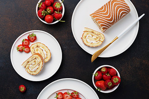 Sweet roll cake with white biscuit containing dark, strawberry, and nobody