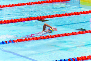 Swimmer child swims freestyle swimming style in a race swimming, a Sports & Recreation Photo by Casanowe-studio