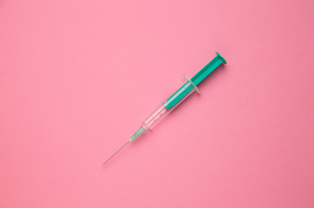 Medical syringe on colorful backgrou
