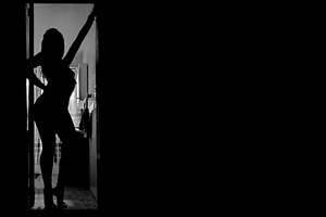 Woman silhouette posing at open door room, a Beauty & Fashion Photo by DanFLCreativo